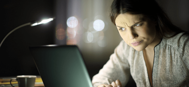Woman look confused at screen 
